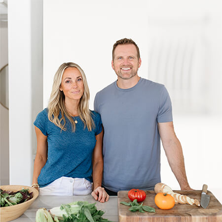 Lillie and Ross together with a chopping block and some vegetables.